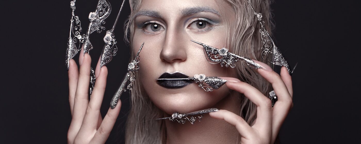 Beautiful girl with art make up in anime style, creative long nails. Design manicure. Beauty face.